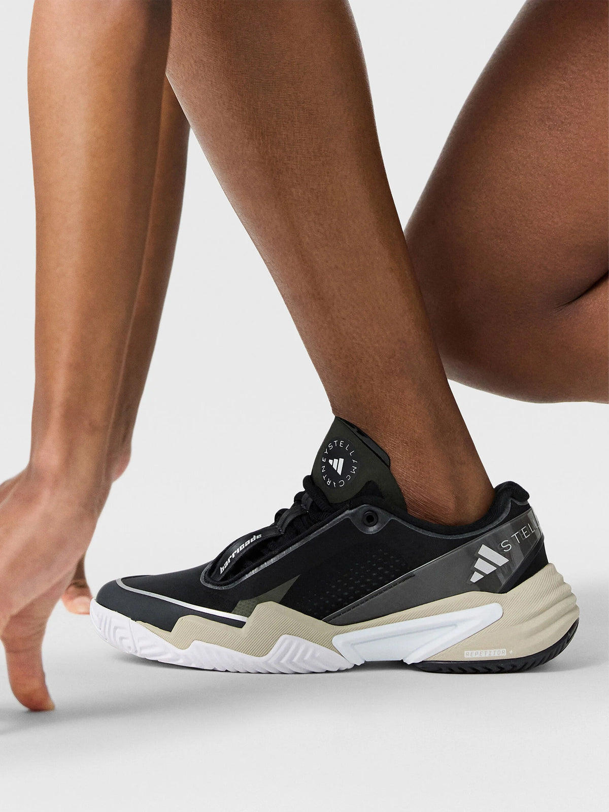 Core Black, Almond Milk and Metallic Silver Barricade Tennis Shoes